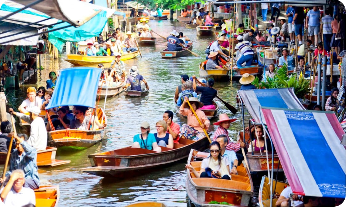 Bustling Bangkok Floating Market with wooden boats showcasing apopular tourist places in Thailand