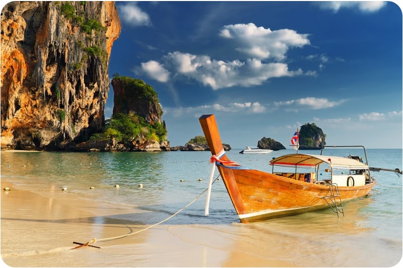 A traditional longtail boat on the shore of Chaweng Beach, a popular place to visit in Thailand for sun, sand, and sea.