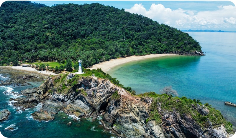 A picturesque beach and lighthouse on Koh Lanta, a popular tourist destination in Thailand.