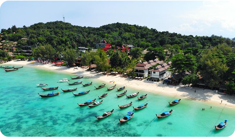 Beautiful beach scene with longtail boats in Koh Lipe, a must-see place in Thailand.