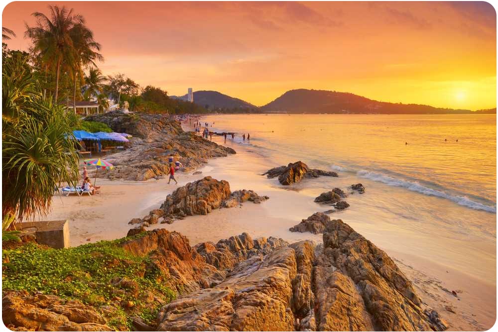 A beautiful sunset over Patong Beach in Thailand, one of the top places to visit in Thailand.